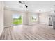 Light and airy living area with vinyl floors, stainless steel refrigerator, and views of the lush outdoors at 2041 Greenbriar Ter, Davenport, FL 33837