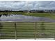 Balcony view showcasing a tranquil pond and a beautifully landscaped golf course community at 2041 Greenbriar Ter, Davenport, FL 33837