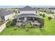 Aerial view of backyard featuring lush lawn and screened patio with outdoor seating, creating a perfect oasis at 2215 Upland Ln, Apopka, FL 32712