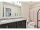 Bathroom featuring double vanity, granite countertops, and shower-tub combo, perfect for everyday convenience at 2215 Upland Ln, Apopka, FL 32712