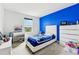 Bright bedroom with blue accent wall and modern furniture, creating a stylish and comfortable retreat at 2215 Upland Ln, Apopka, FL 32712