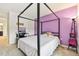 Cozy bedroom with a four-poster bed, desk, and carpeted floors, offering a comfortable and functional living space at 2215 Upland Ln, Apopka, FL 32712