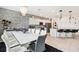 Open-concept kitchen with modern lighting, sleek island with bar seating, and decorative backsplash at 2215 Upland Ln, Apopka, FL 32712