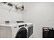 Modern laundry room equipped with a new washer and dryer at 2215 Upland Ln, Apopka, FL 32712