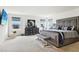 Spacious primary bedroom boasts carpet floors, a large window with views, and stylish furniture, creating an inviting space at 2215 Upland Ln, Apopka, FL 32712