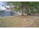Backyard featuring mature tree coverage, partial fence and a grassy area at 2307 Freemason St, Lakeland, FL 33801