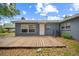 The backyard features a wood deck, large windows and a grey exterior at 2307 Freemason St, Lakeland, FL 33801