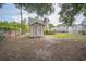 Backyard featuring a storage shed, partial fence and a grassy area at 2307 Freemason St, Lakeland, FL 33801