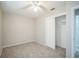 This bedroom features neutral walls, ceiling fan, carpet flooring, and a closet at 2307 Freemason St, Lakeland, FL 33801