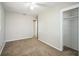 This bedroom features neutral walls, ceiling fan, carpet flooring, and a convenient closet at 2307 Freemason St, Lakeland, FL 33801