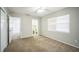 Neutral bedroom with carpet, ceiling fan, and a large window providing natural light at 2307 Freemason St, Lakeland, FL 33801