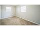 Spare bedroom with plush carpet, baseboard trim and two windows at 2307 Freemason St, Lakeland, FL 33801