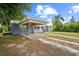 Cozy one-story home featuring a covered carport and a neatly maintained front yard landscape at 2307 Freemason St, Lakeland, FL 33801