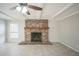 Living room showcasing a beautiful brick fireplace with a wooden mantle at 2307 Freemason St, Lakeland, FL 33801