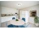 Bright kitchen featuring white cabinets, granite countertops, and a cozy dining area at 2307 Freemason St, Lakeland, FL 33801