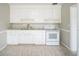 Clean kitchen with white cabinets, granite countertops, tile flooring, and modern appliances at 2307 Freemason St, Lakeland, FL 33801