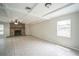Spacious living room features a brick fireplace and coffered ceiling at 2307 Freemason St, Lakeland, FL 33801