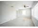 Open living room with neutral walls, new carpet, ceiling fan and natural light at 2307 Freemason St, Lakeland, FL 33801