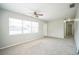 Spacious living room with ample natural light, updated carpet, and a modern ceiling fan at 2307 Freemason St, Lakeland, FL 33801