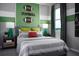 Themed bedroom with football decor, striped walls, cozy bedding, and bedside lamps for a fun and inviting space at 2524 Raghav Trl, Tavares, FL 32778