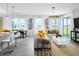 Open-concept living room and dining area featuring ample natural light and stylish modern decor with tile flooring at 2524 Raghav Trl, Tavares, FL 32778