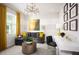 Cozy sitting room with striped walls, a comfortable gray sofa, modern lighting, and a white desk area at 2524 Raghav Trl, Tavares, FL 32778
