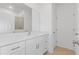 Bathroom featuring a white vanity with countertop, mirror, and white cabinets with chrome pulls at 2533 Raghav Trl, Tavares, FL 32778