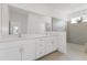 Modern bathroom featuring double sinks, a large mirror, and a glass-enclosed shower at 2533 Raghav Trl, Tavares, FL 32778