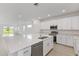 Open-concept kitchen with large island, stainless steel appliances, and ample cabinet space at 2533 Raghav Trl, Tavares, FL 32778
