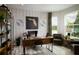 A modern home office with a stylish wooden desk, comfortable seating, and a bright window at 3114 Suraj Cir, Tavares, FL 32778