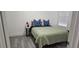 Serene bedroom with laminate flooring, a cozy bed, and natural light at 320 Forestway Cir # 107, Altamonte Springs, FL 32701