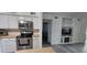 Bright kitchen with stainless steel appliances, white cabinets, and open view to living area at 320 Forestway Cir # 107, Altamonte Springs, FL 32701