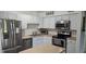 Updated kitchen featuring stainless steel appliances, white cabinets, and a cozy island at 320 Forestway Cir # 107, Altamonte Springs, FL 32701