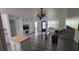 Bright living room with built-in shelving, laminate floors, and access to front door at 320 Forestway Cir # 107, Altamonte Springs, FL 32701