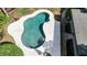 Overhead view of a backyard swimming pool featuring a unique kidney bean shape and surrounding concrete at 359 Westwind Ct, Lake Mary, FL 32746