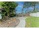 Serene backyard with a cozy fire pit area, mature trees, and lush green grass at 359 Westwind Ct, Lake Mary, FL 32746