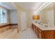 Bright bathroom featuring a double vanity, neutral tile, and a tub under a window at 359 Westwind Ct, Lake Mary, FL 32746