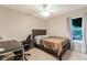 Simple bedroom with a desk, chair, and window providing a functional and comfortable space at 359 Westwind Ct, Lake Mary, FL 32746