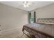 Neutral bedroom featuring a metal bed frame, ceiling fan, and plush carpet at 359 Westwind Ct, Lake Mary, FL 32746