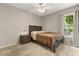 Inviting bedroom with a queen bed, side table, and natural light streaming through the window at 359 Westwind Ct, Lake Mary, FL 32746