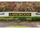 Lakewood community sign featuring a black and gold sign framed by lush greenery and vibrant pink flowering trees at 359 Westwind Ct, Lake Mary, FL 32746