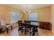 Dining area featuring a rustic table with modern chairs and lighting at 359 Westwind Ct, Lake Mary, FL 32746