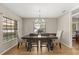 Elegant dining room with a chandelier, table set for six, and natural light creating a warm ambiance at 359 Westwind Ct, Lake Mary, FL 32746