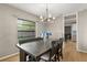 Well-lit dining area featuring a wooden table, comfortable seating, and a chandelier creating an inviting space at 359 Westwind Ct, Lake Mary, FL 32746