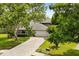 A view of the house showcasing its gray exterior, well-kept lawn, and a long driveway for easy parking at 359 Westwind Ct, Lake Mary, FL 32746