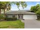 Charming single-story home featuring a manicured lawn and attached two-car garage, perfect for suburban living at 359 Westwind Ct, Lake Mary, FL 32746