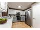 Modern kitchen with stainless steel appliances and white cabinets, virtually staged at 359 Westwind Ct, Lake Mary, FL 32746