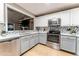 Updated kitchen with stainless steel appliances, stone countertops, and decorative backsplash at 359 Westwind Ct, Lake Mary, FL 32746