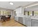 Bright kitchen with modern gray cabinets, stainless steel appliances, and an adjacent eat-in area, ideal for casual dining at 359 Westwind Ct, Lake Mary, FL 32746