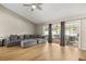 Sun-filled living room with wood flooring, a gray sectional, and sliding glass doors to the patio at 359 Westwind Ct, Lake Mary, FL 32746